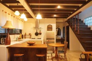 a kitchen with a staircase and a table and chairs at Foresta Villa in Hang Dong