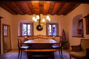 a dining room with a wooden table and chairs at Living History (adults only) in Hallstatt