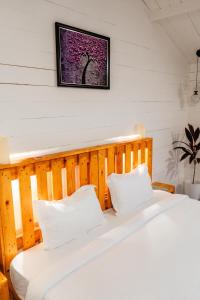 two beds in a room with a picture on the wall at The Pearl Beach Resort in Canacona