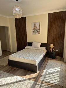 ein Schlafzimmer mit einem Bett und einem Kronleuchter in der Unterkunft madinaty in Madinaty