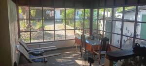 a room with a large window with a desk and chairs at Plage 65 in San Juan