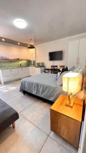 a bedroom with a bed and a table with a lamp at Lagoon Lodge in Cape Town