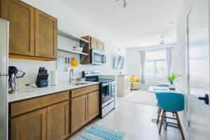 a kitchen with wooden cabinets and a blue chair at studios180 in Lexington