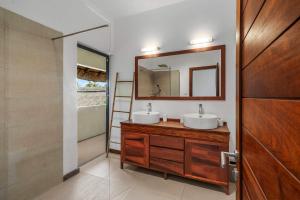 une salle de bain avec deux lavabos et un miroir dans l'établissement Villa Nayla - Ocean retreat by Sealodge, à Rivière Noire 21 autres photos
