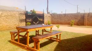 a picnic table and a bench in the grass at 33 On Swallows Guest House in Soshanguve
