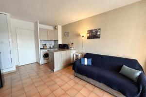 a living room with a couch and a kitchen at This comfortable and bright apartment WIFI in Grimaud