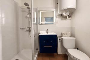 a bathroom with a toilet and a sink and a shower at This comfortable and bright apartment WIFI in Grimaud