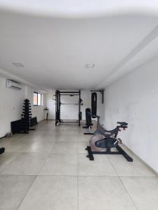 a room with a gym with a treadmill and a exercise bike at Apartamento para suas férias ou trabalho in João Pessoa