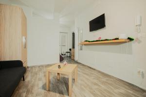 a living room with a couch and a table at Free Parking - Da Raf in Marano di Napoli