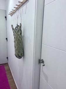 an open door with a bag hanging from it at Casa Kiwi Playa a 50 metros in El Palmar +27 photos