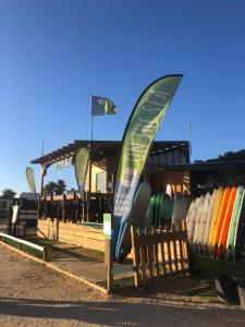 a bunch of surfboards are lined up in a rack at Casa Kiwi Playa a 50 metros in El Palmar