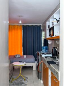 a small room with a bed and a table at Mex Homes Studio in Nairobi