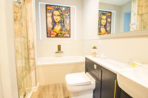 a bathroom with a sink toilet and a mirror at NEW Hot tub, 2 bedrooms, countryside by the coast, 5 Star Woodlands Lodge in Skegness
