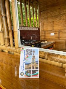 a sign sitting on a table next to a window at Cabaña La Esperanza in San Bernardo