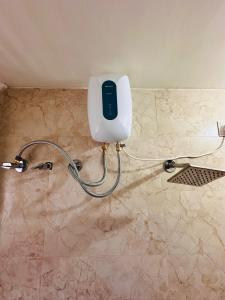 a phone on a wall in a bathroom at Owls Retreat 2BHK Modern AC Flat in Wakad Pune in Méribel Village +24 photos