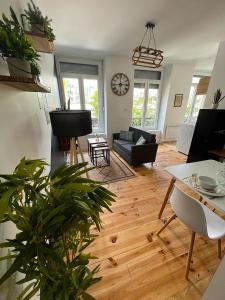 a living room with a couch and a table at Evasion romantique & spa in Saint-Étienne