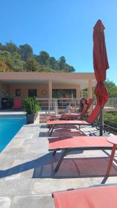 a group of chairs and umbrellas next to a pool at Les Hauts du Peireguier in La Motte +30 photos