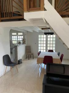 a dining room with a white table and chairs at Villa LUCIE in Le Vauclin