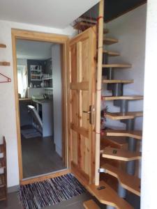 a door leading into a room with a spiral staircase at Cottage Stela Bohinj in Bohinj