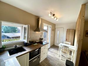a kitchen with a sink and a stove top oven at Studio 263 in Suze-la-Rousse