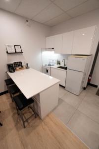 a kitchen with white cabinets and a white counter top at St Jo'Studio in Quebec City +4 photos