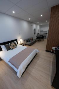a bedroom with a large bed and a living room at St Jo'Studio in Quebec City