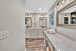 a bathroom with white cabinets and a marble counter at Waterfront Lake House Ideal Dock for Boats, Swimming, Fishing in Moneta +42 photos
