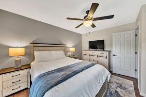 a bedroom with a bed and a ceiling fan at Waterfront Lake House Ideal Dock for Boats, Swimming, Fishing in Moneta