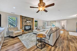 a living room with a couch and a ceiling fan at Waterfront Lake House Ideal Dock for Boats, Swimming, Fishing in Moneta