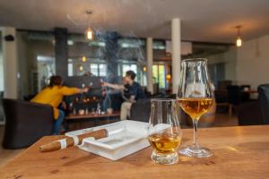 una mesa con dos copas de vino y un bar en Aparthotel Bären, en Seengen