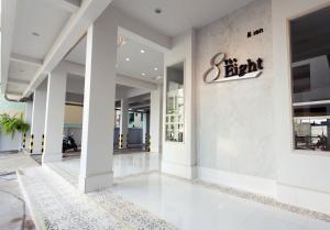 a lobby of a hotel with a sign on the wall at The Eight in Samut Sakhon