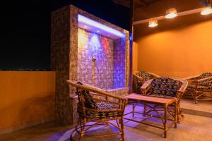 a room with chairs and a table and a door at Airport INN Hotel in Lomé