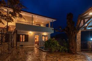 a house with a tree in front of it at night at Villa Kleino - 30 min from Meteora in Kalabaka +31 photos