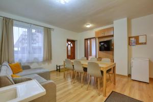 a living room with a table and a couch at Willa Teresa in Karpacz