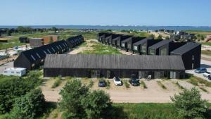 a large building with cars parked in a parking lot at Modern Svencelė Cottage I-Friends and Family in Svenele