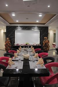 a conference room with a long table and red chairs at Le Parisien Tunis in Tunis