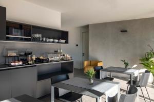 a kitchen with two tables and a counter at Bfour in Pergine Valsugana