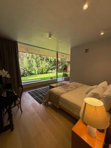 a bedroom with a bed and a large window at Parque Juan Diego in Guadalajara +62 photos