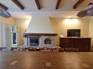 a living room with a fireplace and a tv at B&B Casa Ciarpella in Montegranaro