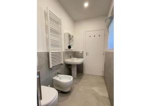 a bathroom with a toilet and a bidet and a sink at Comodissimo Gaslini e mare in Genoa +37 photos