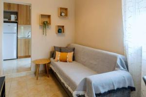 a living room with a couch and a table at Anelia's Home in Makri