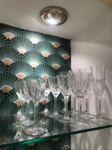 a bunch of wine glasses sitting on a shelf at Domus Gaia in Rome