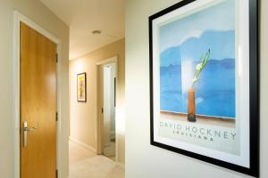 a framed picture on a wall in a hallway at The Hockney - 2 Bd Hip Ap Ultra Fast WIFI in Belfast