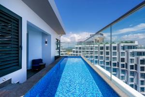 a swimming pool on the balcony of a building at Mandala Cham Bay Hotel Mũi Né in Mui Ne