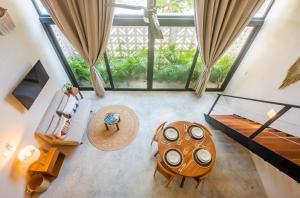 an overhead view of a living room with a table at Bright 2BR Loft with Rooftop Pool in Best Tulum Downtown Location in Tulum