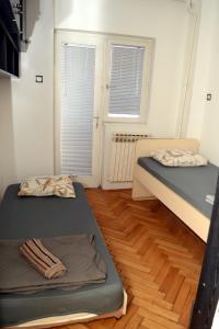 Postel nebo postele na pokoji v ubytování Vladimir Apartman