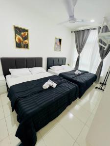 ein Schlafzimmer mit einem großen Bett mit zwei Handtüchern darauf in der Unterkunft Ipoh Anderson Suites by Migliore in Ipoh