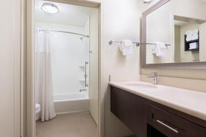 a bathroom with a sink and a shower at Staybridge Suites - Miami International Airport by IHG in Miami