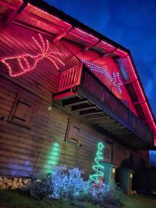 a house with christmas lights on the side of it at chalet 2007 in Le Boulay +8 photos