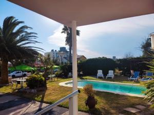 a view of a swimming pool from a house at Hotel Mesón Do Vento in Piriápolis